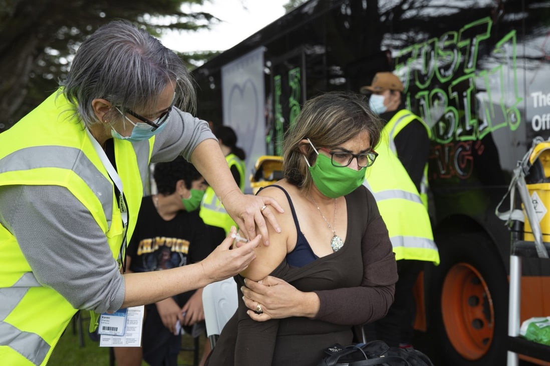 A woman receives a vaccination against Covid-19 at a mobile clinic in Auckland. Photo: NZ Herald via AP