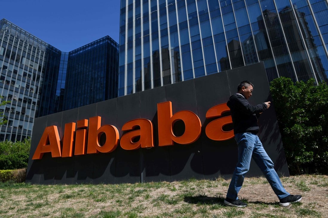 A man walks past an Alibaba sign outside the company's office in Beijing on April 13, 2021. Photo: AFP