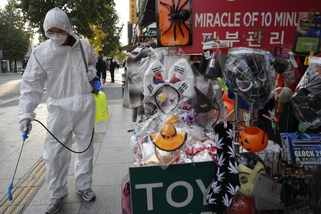 A man disinfects a street in Seoul, South Korea. English words are increasingly visible on street signs, much to the displeasure of Hangul’s many fans. Photo: AP