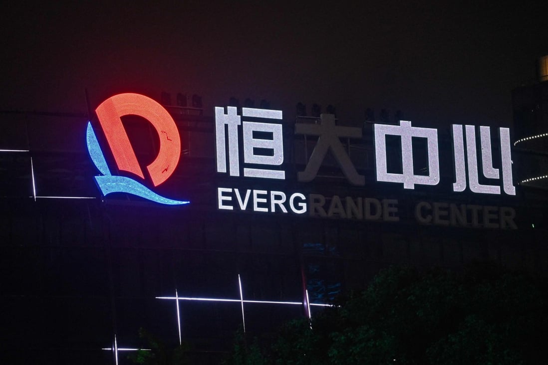 A partially illuminated sign of the Evergrande Center sign at the developer’s building in Shanghai on October 9, 2021. Photo: AFP