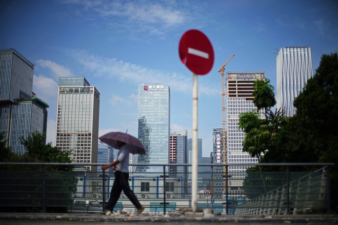 A man walks past a No Entry traffic sign near the headquarters of China Evergrande Group in Shenzhen on September 26, 2021. Photo: Reuters