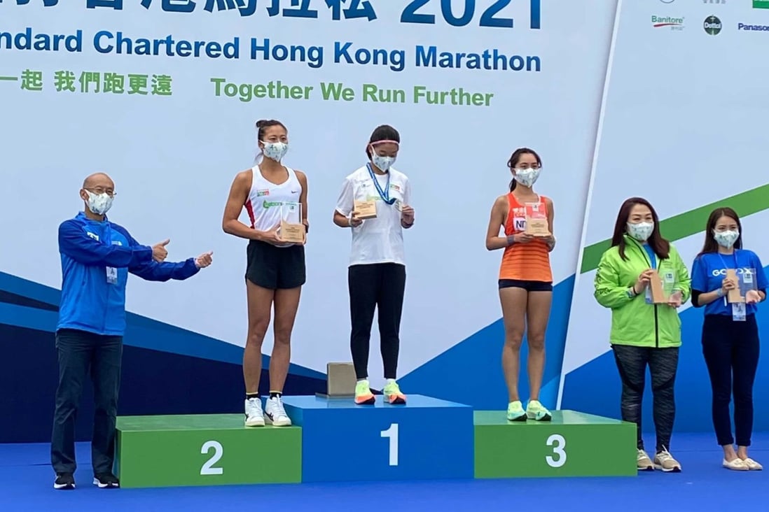 Distance runner Virginia Lo Ying-chiu tops the women’s 10km podium at the 2021 Standard Chartered Hong Kong Marathon ahead of second placed Hilda Choi Yan-yin. Photo: Andrew McNicol