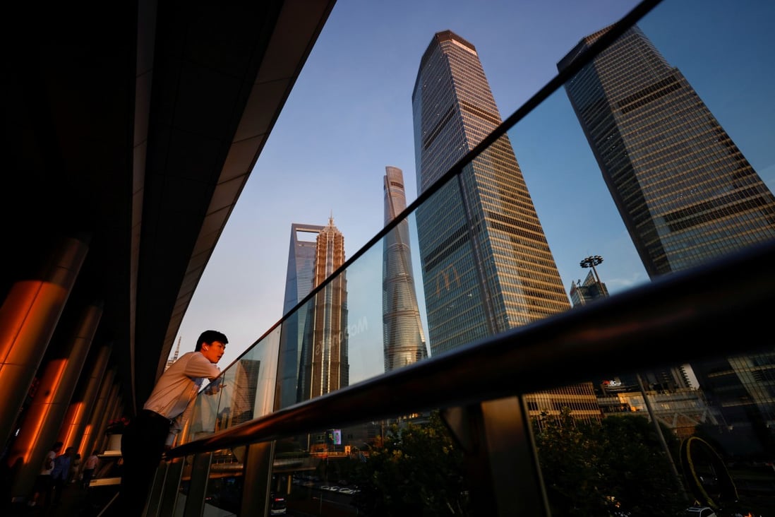 A man makes a phone call through the headset in the Lujiazui financial district in Pudong, Shanghai in July 2021. Photo: Reuters