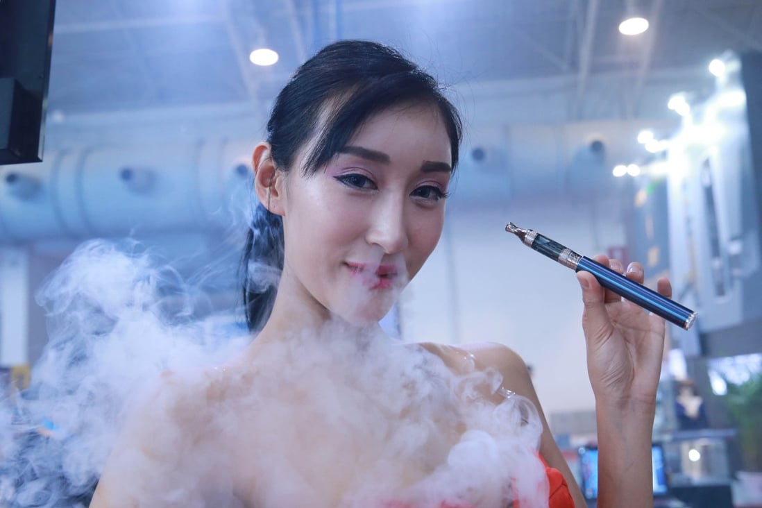 A model smokes an electronic cigarette during the Beijing International Vapour Distribution Alliance Expo at China International Exhibition Center on July 23, 2015 in Beijing, China. Photo: Getty