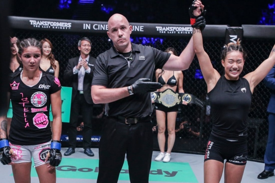 Angela Lee's arm is raised after her 2017 atomweight title win against Istela Nunes. Photos: ONE Championship
