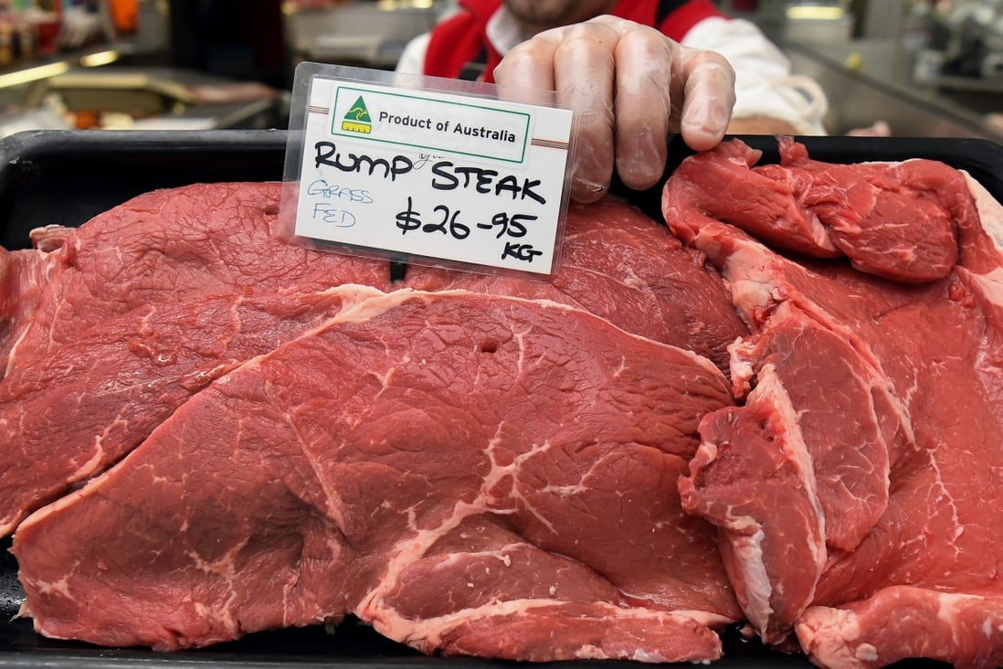 A butcher holds up a tray of Australian rump steaks in Melbourne. File photo: AFP