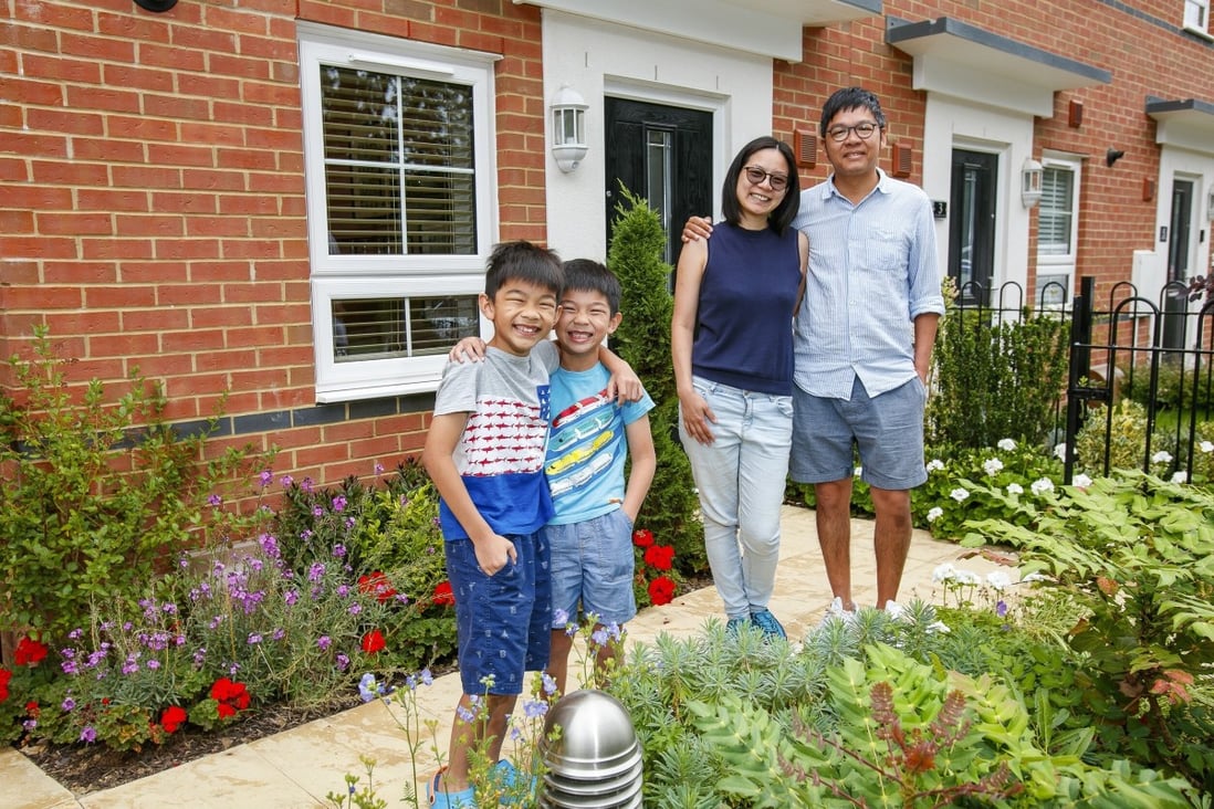 Elise Kong and Ming Wong with their two sons in their new home in Chertsey, Surrey. Photo: Handout