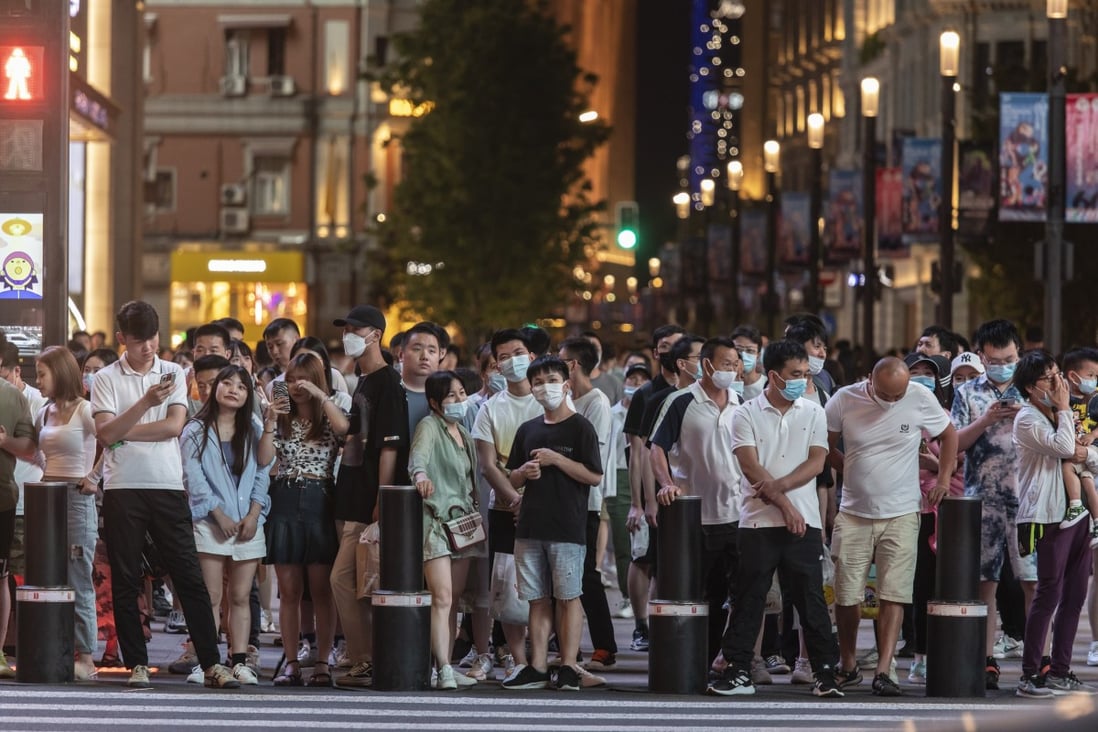 Shoppers and pedestrians wait at a traffic signal at Nanjing Road in Shanghai. For data gathered from the personal information of more than 1 million Chinese, a government review is mandatory before moving it across the border. Photo: Bloomberg