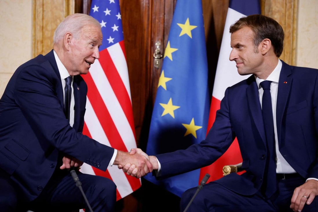 French President Emmanuel Macron (right) and US President Joe Biden shake hands during their meeting at the French embassy to the Vatican in Rome on Friday. Photo: AFP