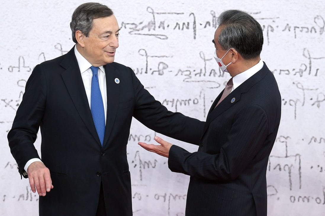 Italian Prime Minister Mario Draghi welcomes Chinese Foreign Minister Wang Yi as he arrives for the G20 summit in Rome on Saturday. Photo: EPA-EFE