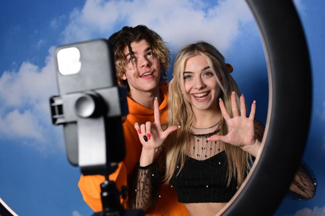 TikTok influencers Florin Vitan (L) and Alessia Lanza perform a video for the social network in the “Defhouse” in Milan on January 21, 2021. Photo: AFP.