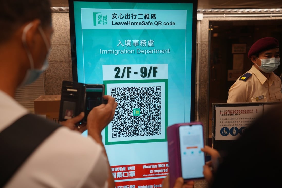 People use the ‘Leave Home Safe’ app before entering Immigration Tower in Wan Chai. Photo: Winson Wong