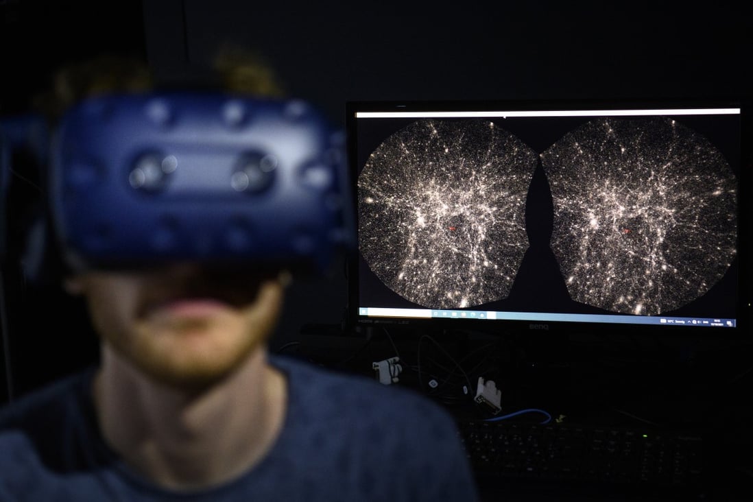 A software engineer at EPFL's Laboratory for Experimental Museology (eM+) explores with a virtual reality helmet the most detailed 3D map of the universe with the virtual reality software VIRUP, developed by Swiss Federal Institute of Technology. Photo: AP