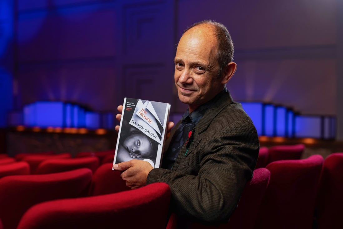 Writer Damon Galgut is seen with his novel, The Promise, at the 2021 Booker Prize Awards Ceremony at the BBC Radio Theatre in London on Wednesday. Photo: Booker Prize Press Office via EPA-EFE