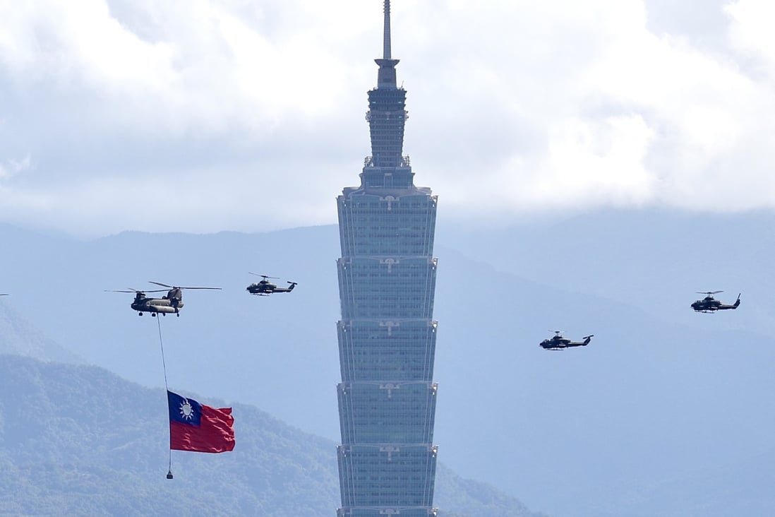 A Chinook and Apache helicopters fly past the Taipei 101 tower in Taiwan. Photo: EPA