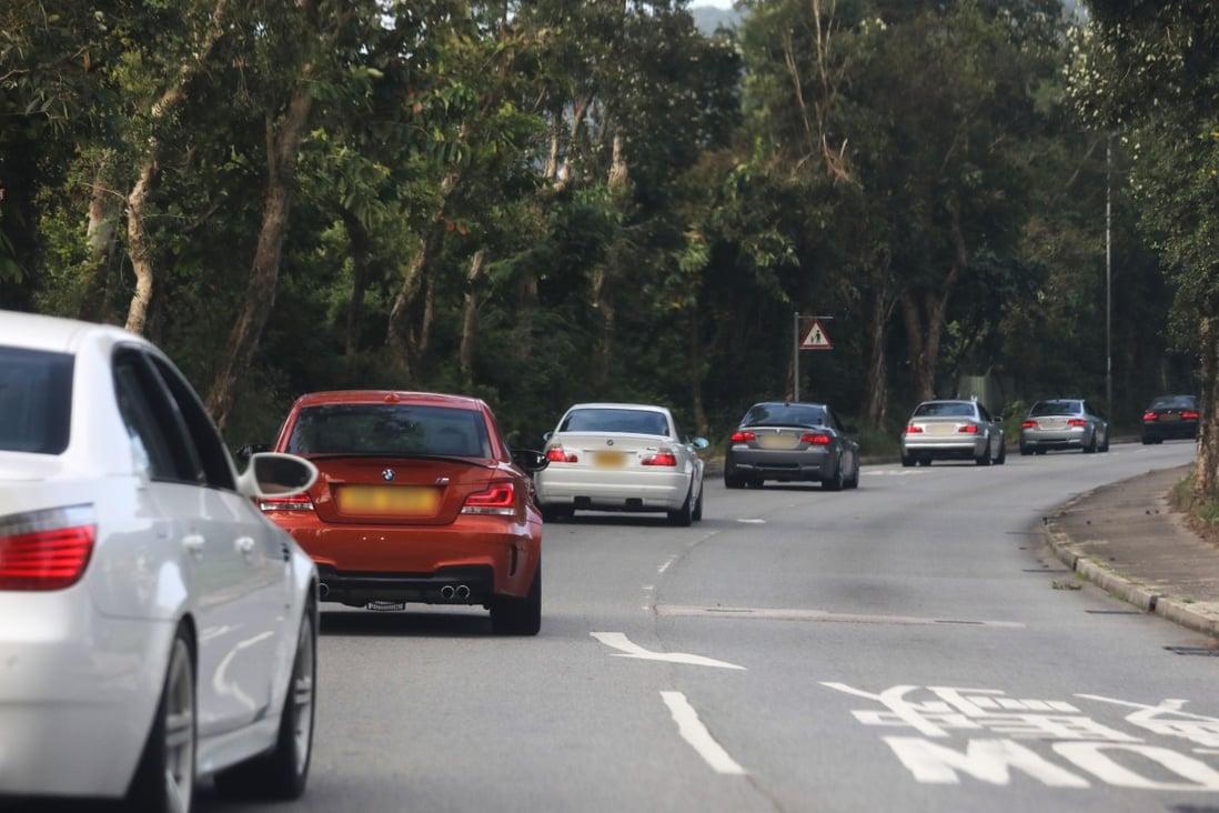 A convoy of BMWs fly past a Post photographer at high speed early on Sunday morning on Bride’s Pool Road in Tai Po. Photo: Xiaomei Chen