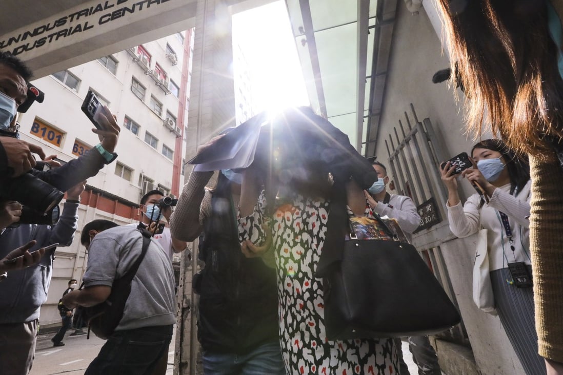Customs officers escort a suspect out of a building on Shing Yip Street, in Kwun Tong. Photo: Felix Wong