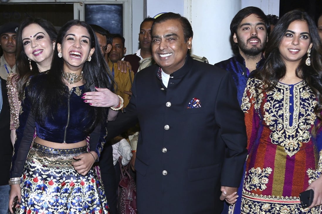 Mukesh Ambani, centre, with his wife and family members in India in 2018. Photo: AP