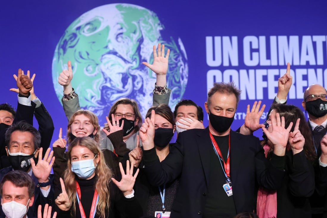 Delegates pose for a picture during COP26 in Glasgow on Saturday. Photo: Reuters