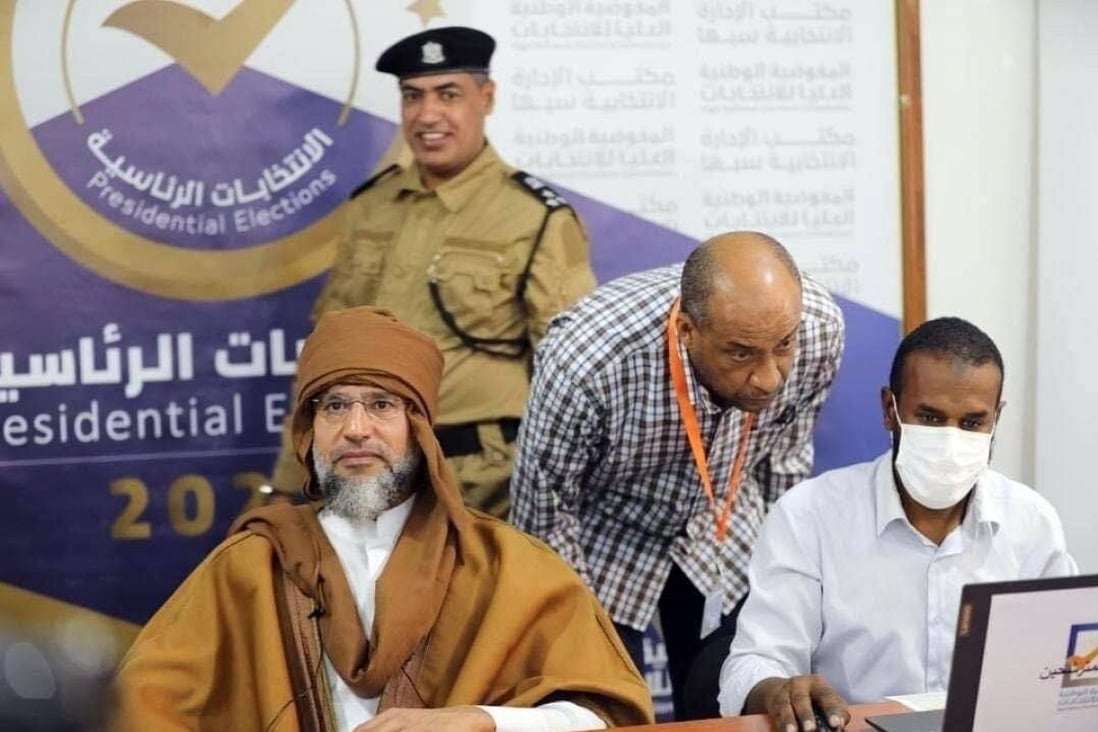 Saif al-Islam Gaddafi, left, son of the former Libyan leader Muammar Gaddafi, registers to run in Libya’s upcoming presidential elections. Photo: EPA-EFE / Libyan Electoral Commission