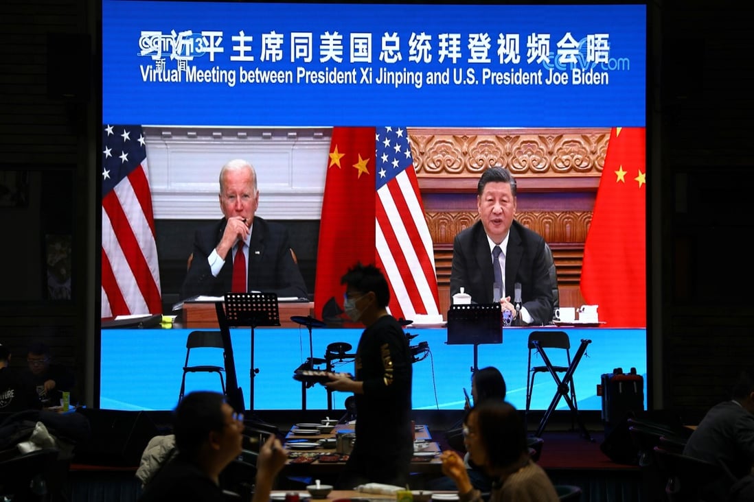 Chinese President Xi Jinping meets US President Joe Biden via video link, as seen at a restaurant in Beijing on November 16. Photo: Reuters