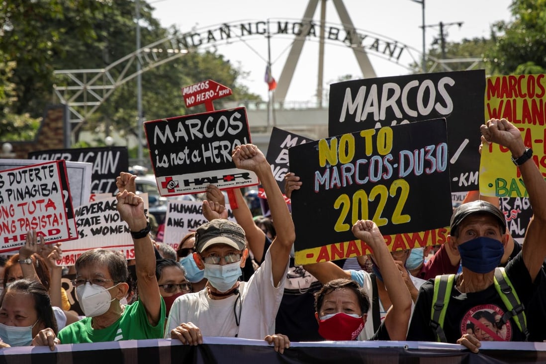 Filipino protesters carry ‘Marcos is no hero’ and ‘never again’ banners ...
