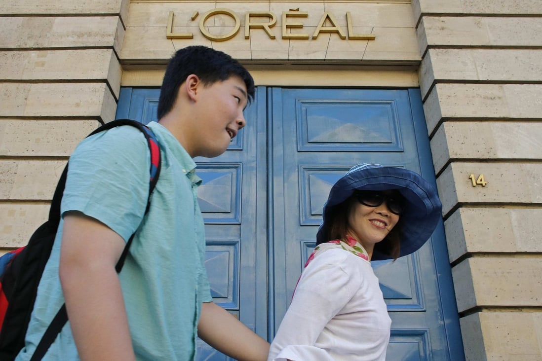 Tourists walk past the entrance of the L‘Oreal building in Paris. The French cosmetics giant is facing a consumer backlash in China over its Singles’ Day promotion for a facial mask. Photo: Reuters
