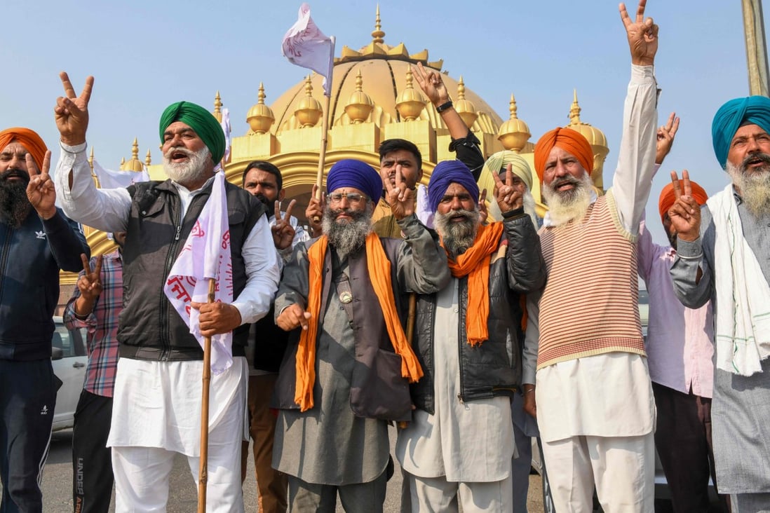 Farmers celebrate after Indian Prime Minister Narendra Modi announced that he will repeal the controversial farm laws in Amritsar on Friday. Photo: AFP