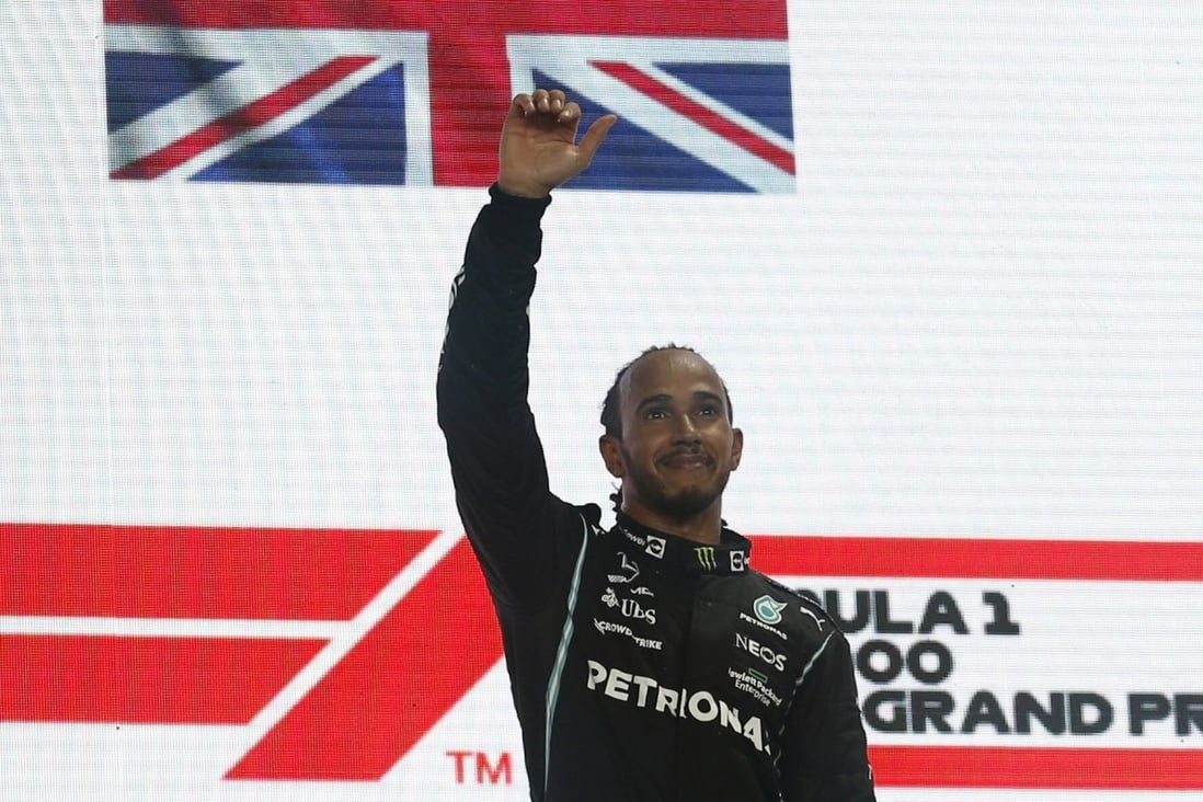 Mercedes’ Lewis Hamilton celebrates on the podium after winning the Qatar Grand Prix on Sunday. Photo: Reuters
