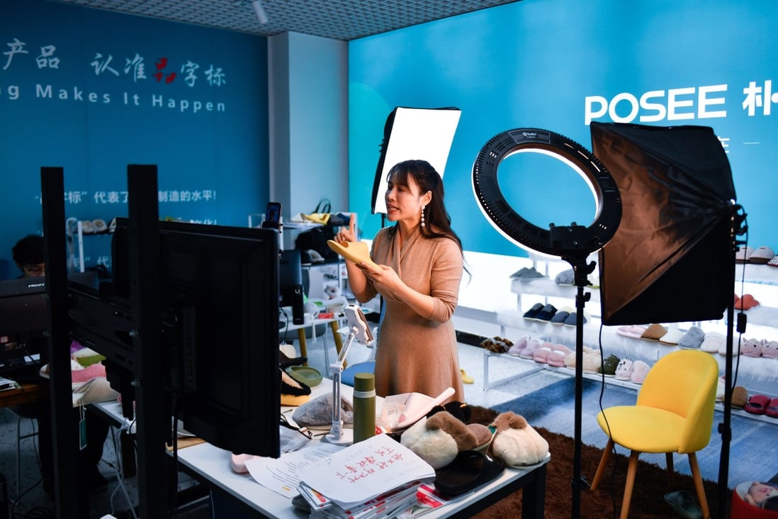 A host introduces products during a live broadcast in Yiwu, in eastern Zhejiang province, on February 8. Live streaming has become a popular way of selling goods on e-commerce platforms like Taobao, but its rapid rise has come with regulatory scrutiny. Photo: Xinhua