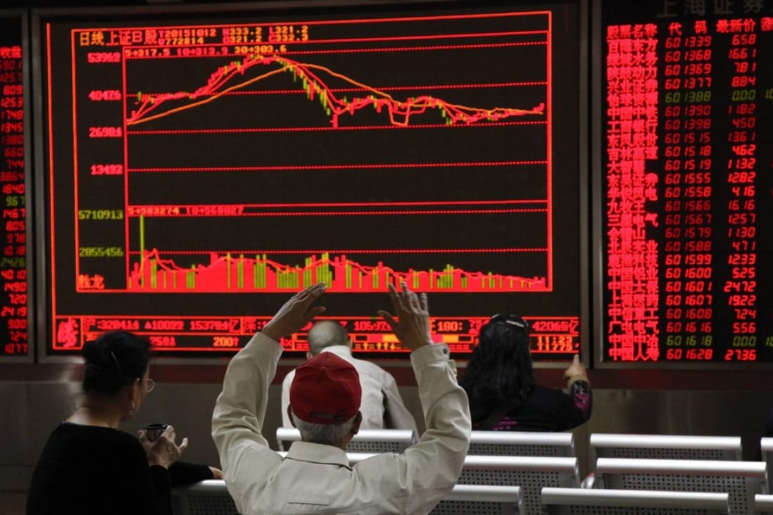 Investors monitor stock market data displayed on an electronic board at a securities brokerage house in Beijing, China. Photo: EPA