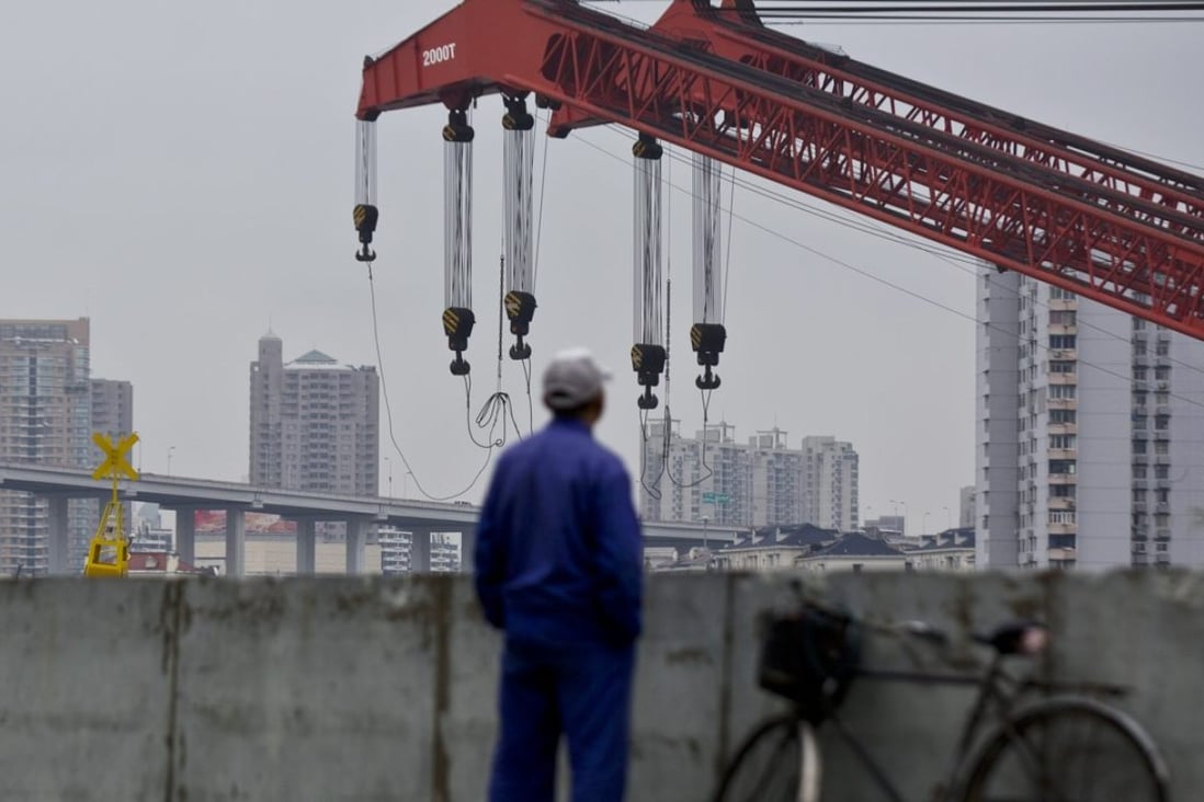 A worker stands on a dock next to the Huangpu river in Shanghai where gains on existing home prices surge at their fastest in 22 months. Photo: Reuters