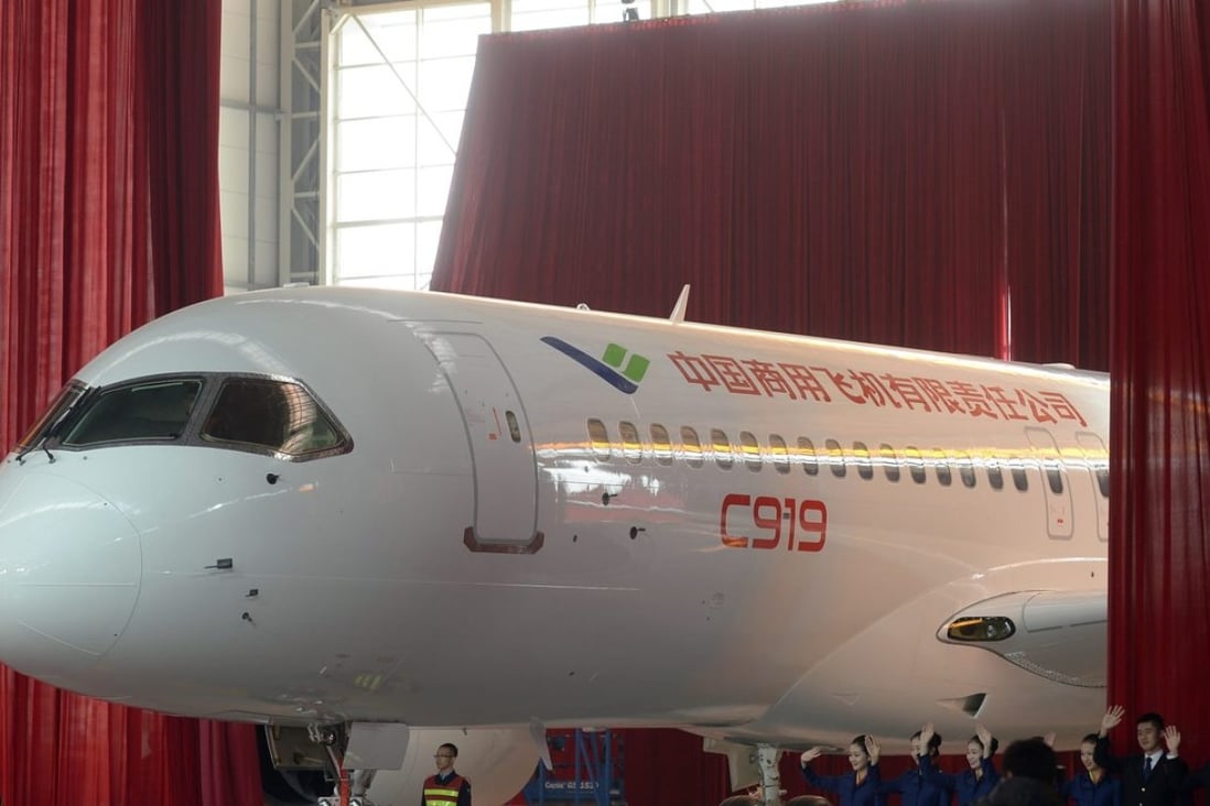 Workers roll out the first C919 passenger jet plane at the state-owned Commercial Aircraft Corporation of China Ltd (COMAC) in Shanghai, China. Photo: EPA