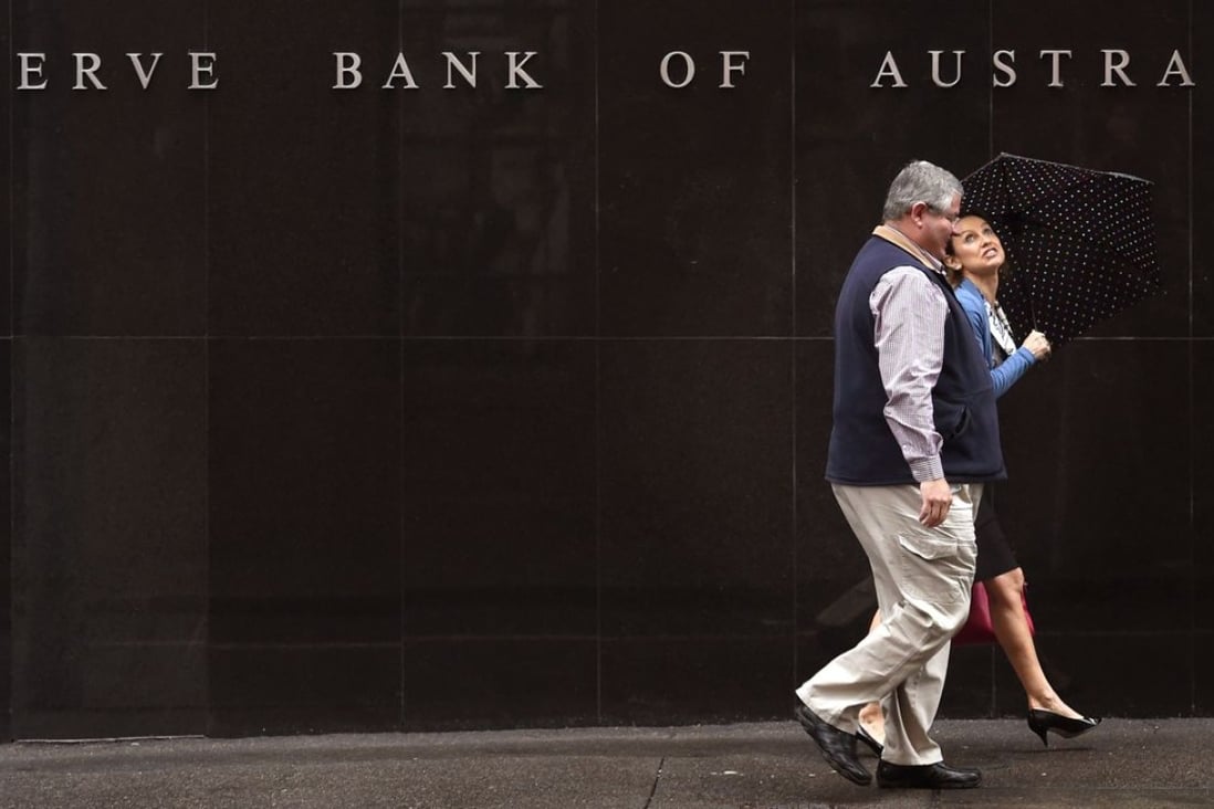 People walk past the Reverse Bank of Australia building in Sydney as investors from China flock to the country to buy up Australian property. Photo: AFP