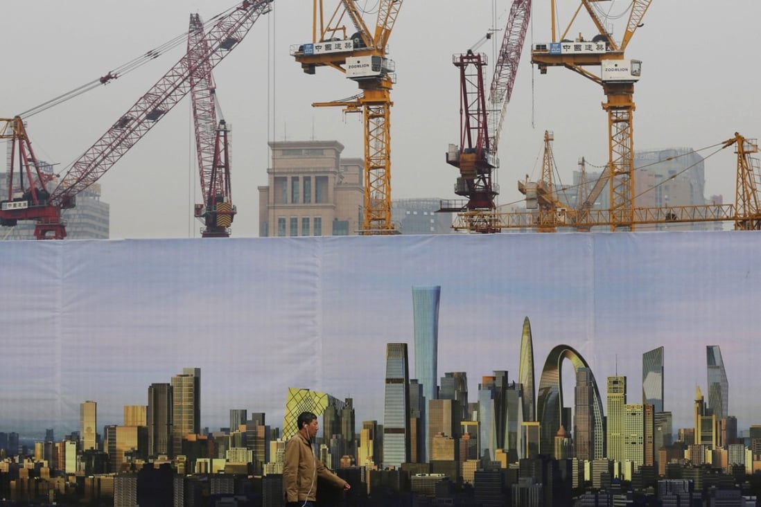 A man walks past a construction site in Beijing. Photo: AP