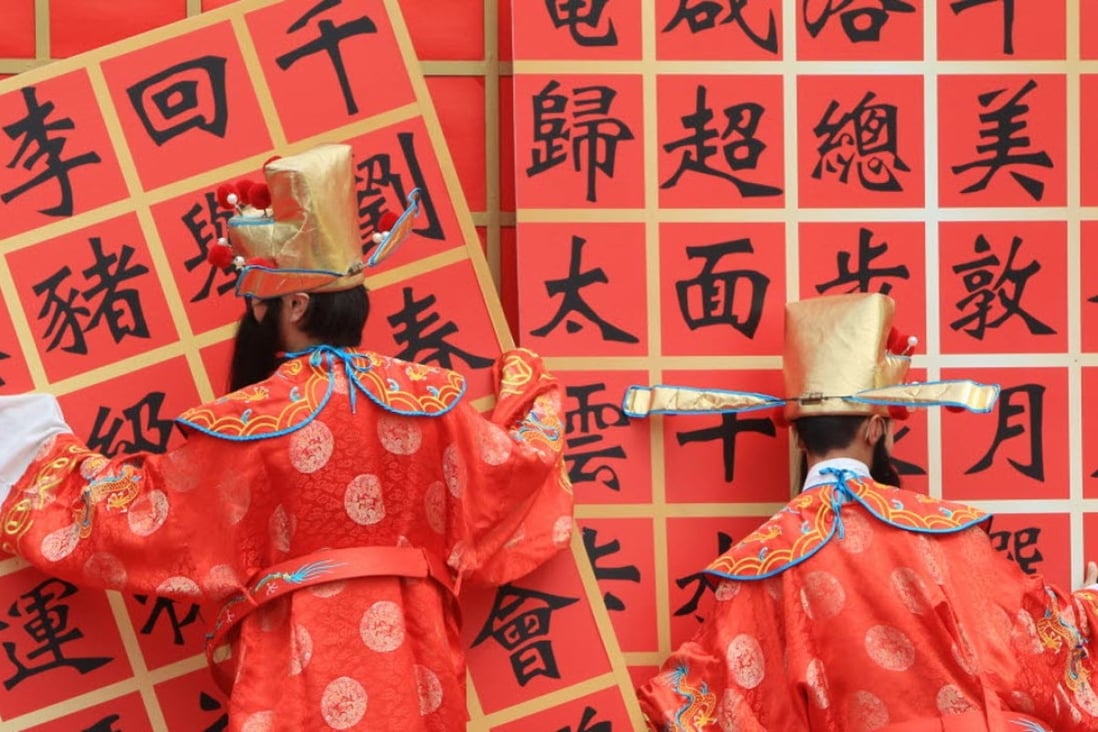 Two performers dress as the Chinese god of wealth at RTHK Lunar New Year Celebration in Kowloon Tong. Wealthy Chinese see Hong Kong as the most important global city. Photo: Jonathan Wong