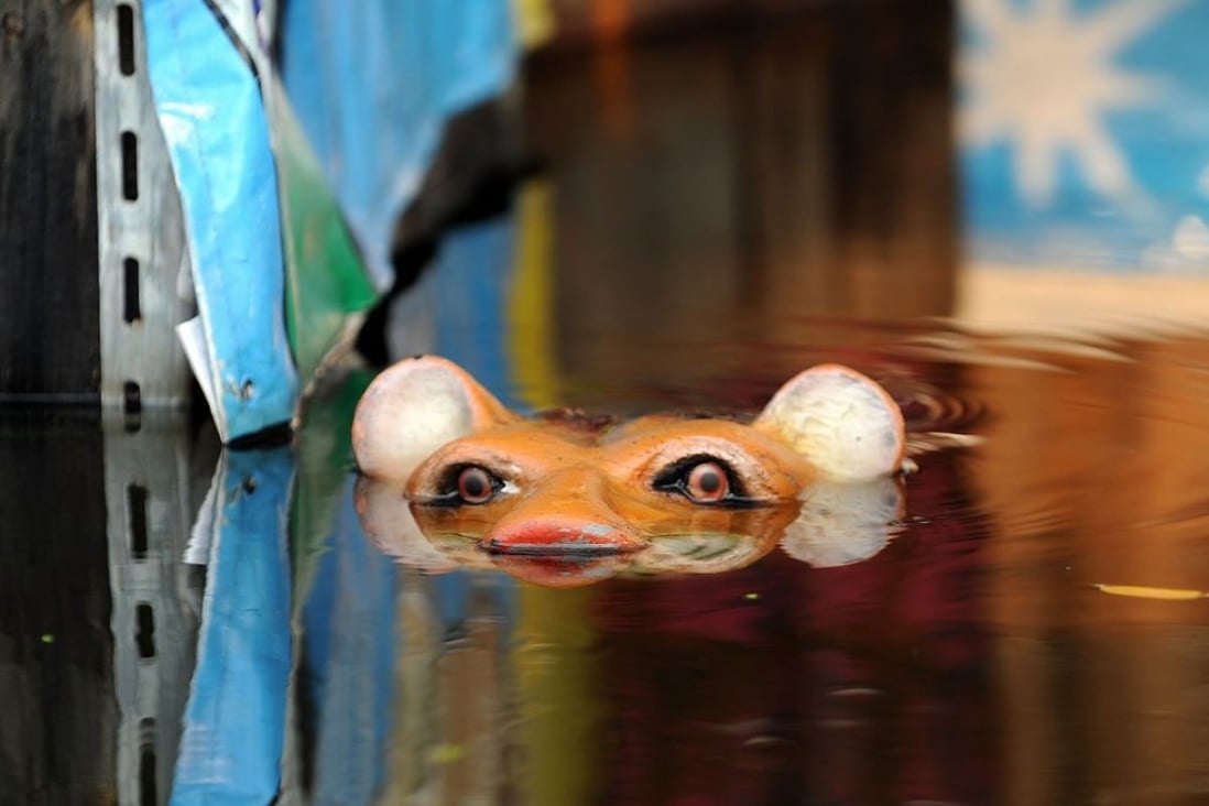 A tiger sculpture pokes out of flood waters in Bangkok in 2011. Photo: AFP