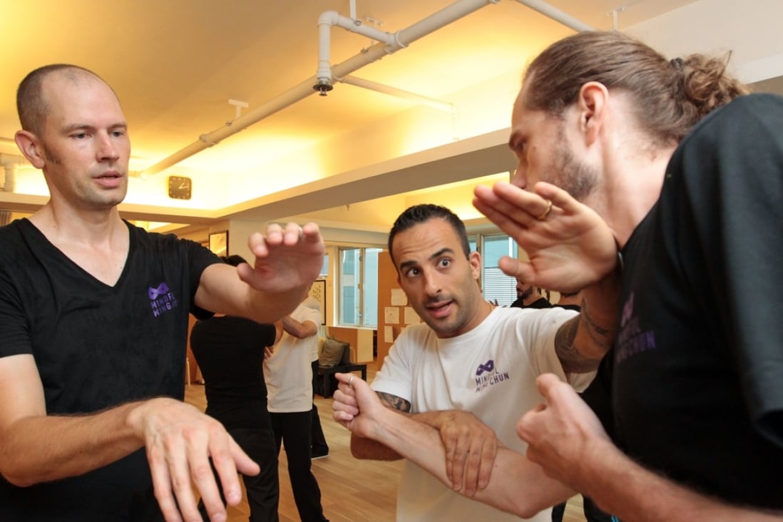 Instructor Nima King (centre) demonstrates wing chun to students at Mindful Wing Chun in Central. Photo: Bruce Yan