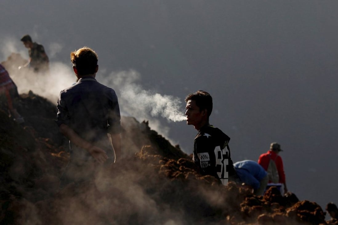 Miners search for jade stones at a mine dump at a Hpakant mine. Photo: Reuters