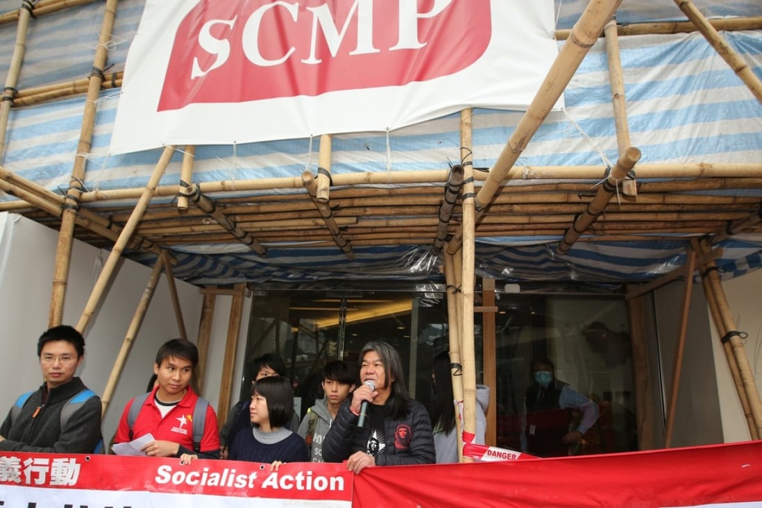 Members of Socialist Action and lawmaker Leung Kwok-hung ‘Long Hair’ (right) picket SCMP’s Leighton Road office against Alibaba’s purchase of the Post. Photo: Edward Wong