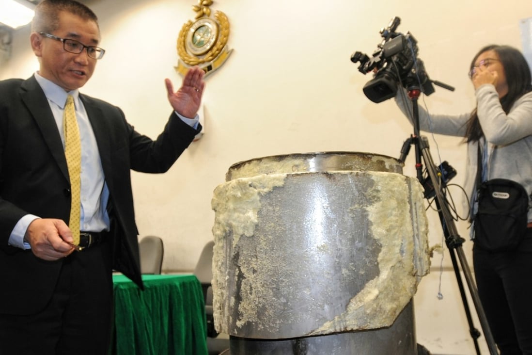 Lee Kwok-keung, group head (airport investigation) of the customs drug investigation bureau, with the industrial machine used to conceal the drugs. Photo: SCMP Pictures