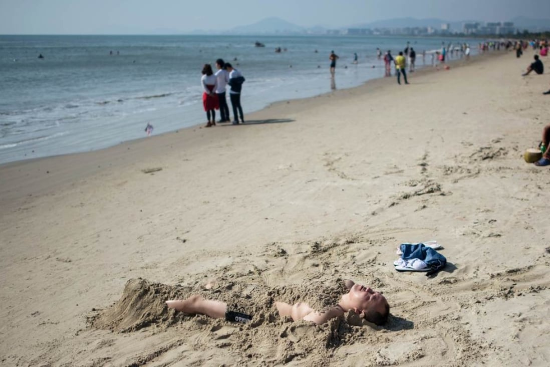 Mainland Chinese tourism is expected to remain a strong growth area. In this photo, a man relaxes on a sandy beach in Sanya on December 18. Photo: AFP