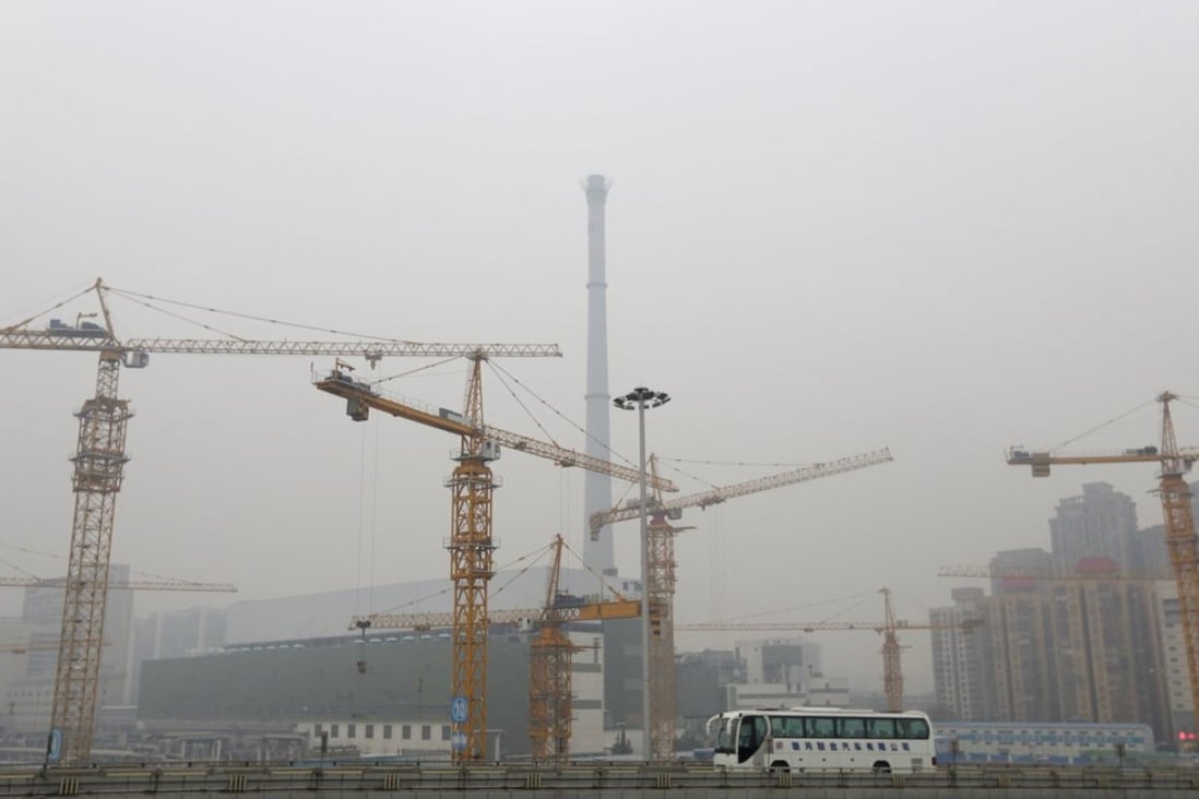 A bus drives past a construction site in Beijing. Photo: Reuters