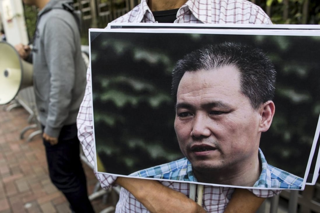 A pro-democracy protester holds a portrait of Chinese human rights lawyer Pu Zhiqiang, demanding his release during a demonstration, outside the Chinese liaison office in Hong Kong, China December 15, 2015. Photo: Reuters