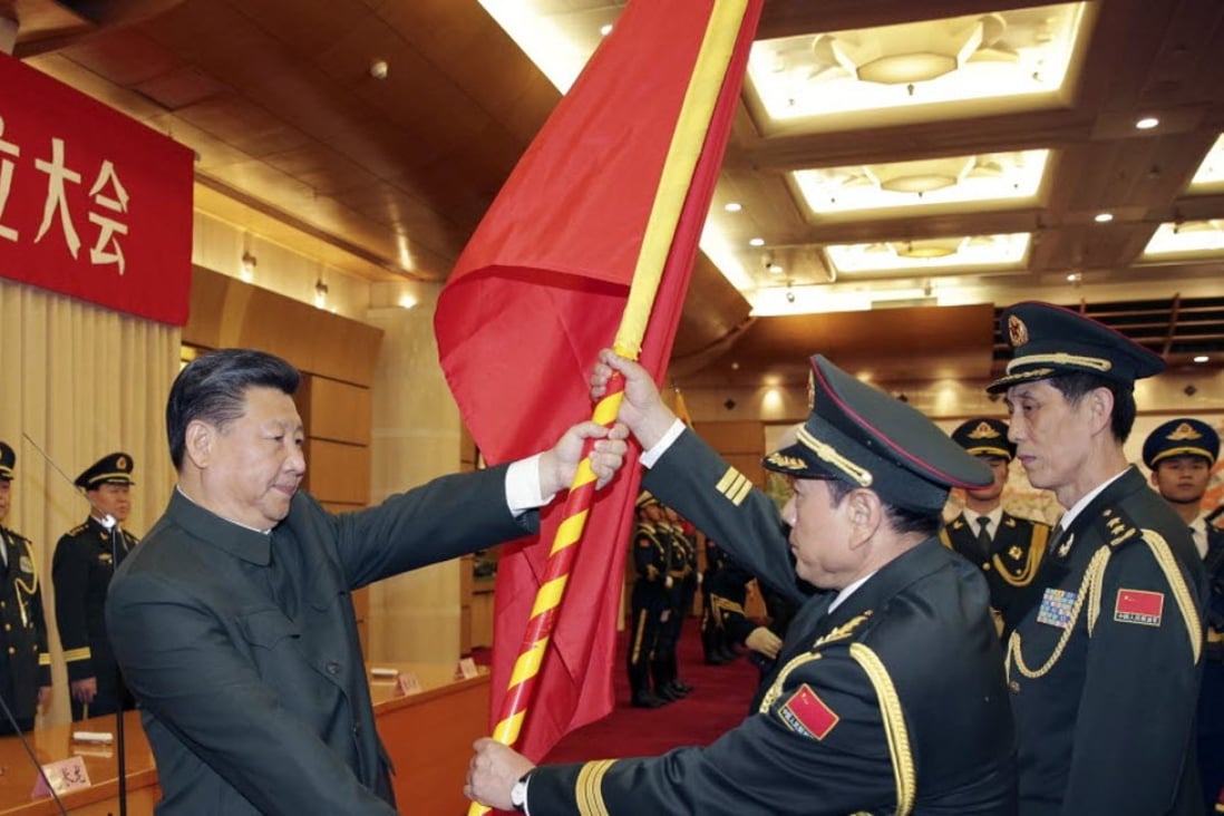 Chinese President Xi Jinping, front left, gives a military flag to Wei Fenghe, commander of the newly formed Rocket Force of the People’s Liberation Army, and Wang Jiasheng, front right, political commissar of the newly formed Rocket Force. Photo: Xinhua