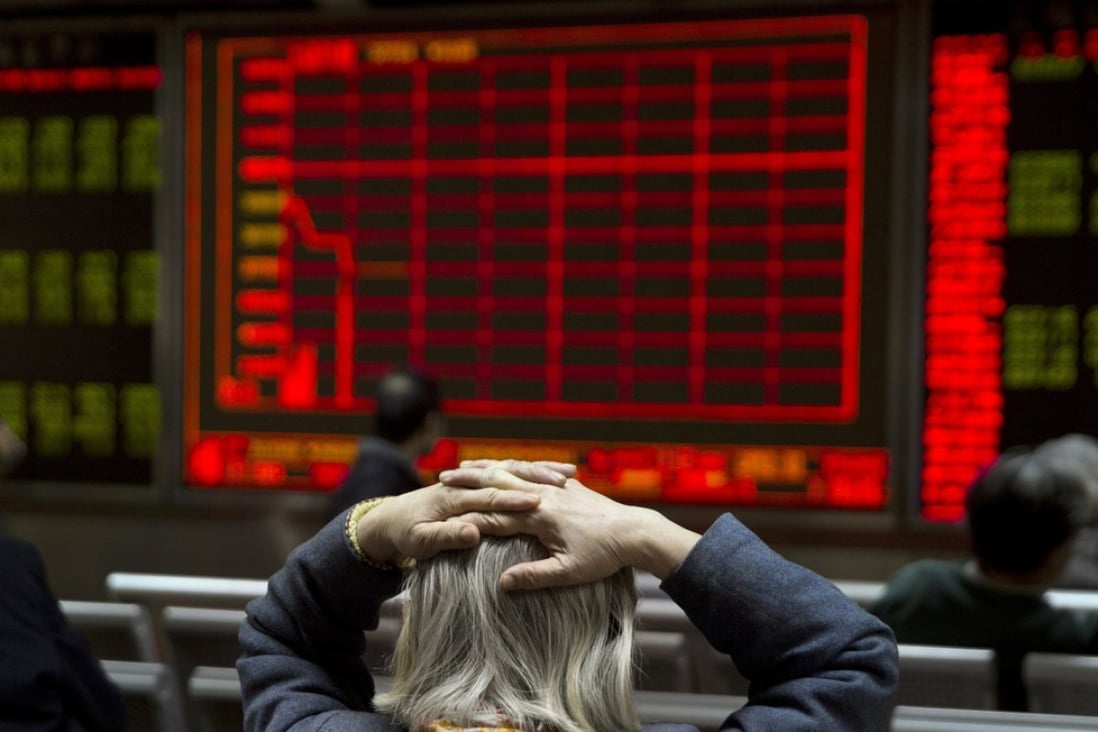 A woman watches Thursday’s meltdown on a display board. Photo: AP