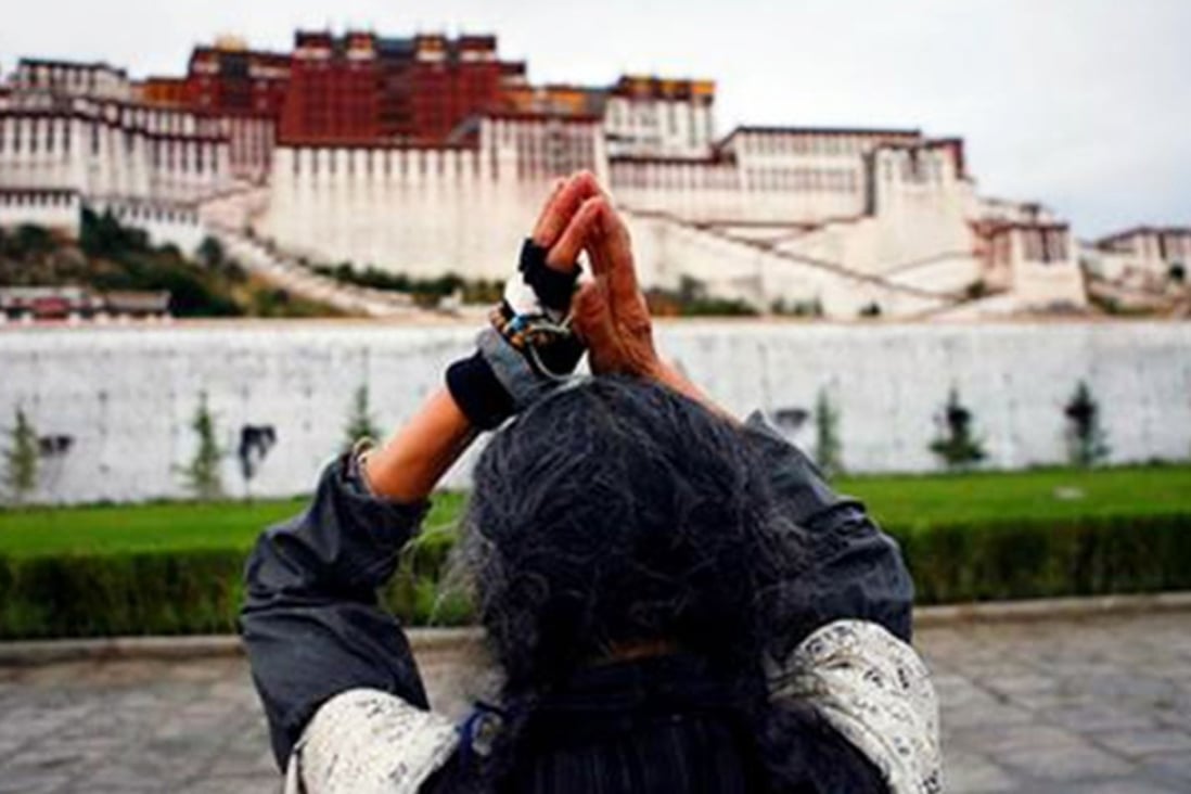 A Buddhist worships outside the Potala palace in Lhasa. Photo: SCMP Pictures