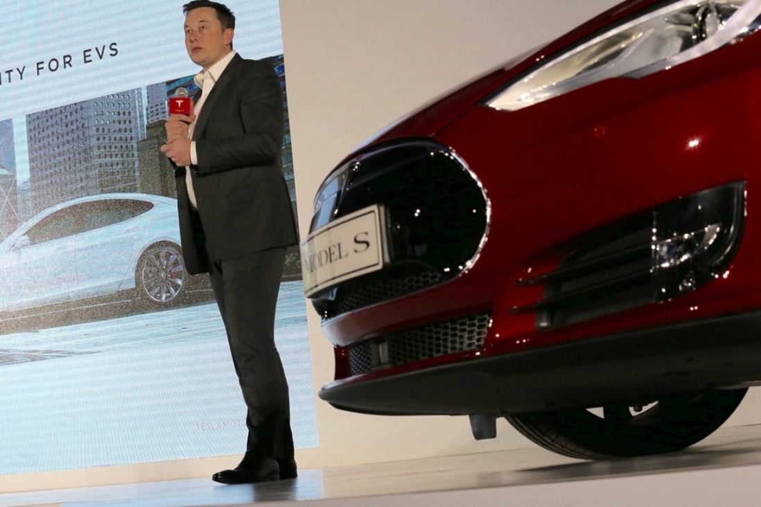 Tesla CEO Elon Musk stands next to a gleaming Model S as he outlines his hopes for the electric cars’ growing popularity in Hong Kong. Photo: Nora Tam