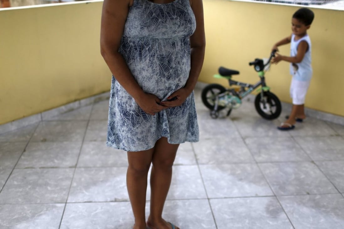 Gisele Felix, who is five months pregnant, stands on a terrace next to her son Joao at her home in Rio de Janeiro, Brazil, on Thursday. Felix, who is concerned about the Zika virus, has not gone out of her house during her 30-day vacation, keeping all the windows and doors closed in an effort to keep out mosquitoes. Photo: Reuters