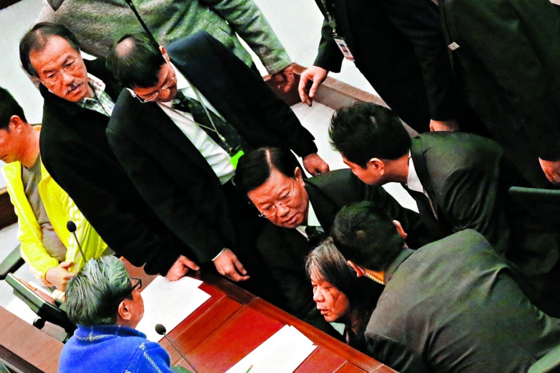 Lawmaker “Long Hair” Leung Kwok-hung is dragged away by security guards during the meeting yesterday. Photo: Edward Wong